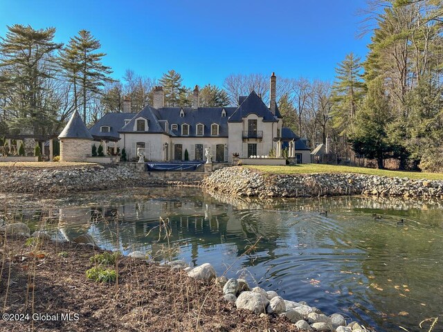 rear view of property featuring a water view