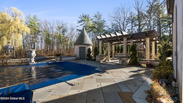 view of pool featuring a patio area, a pergola, and an outdoor fireplace