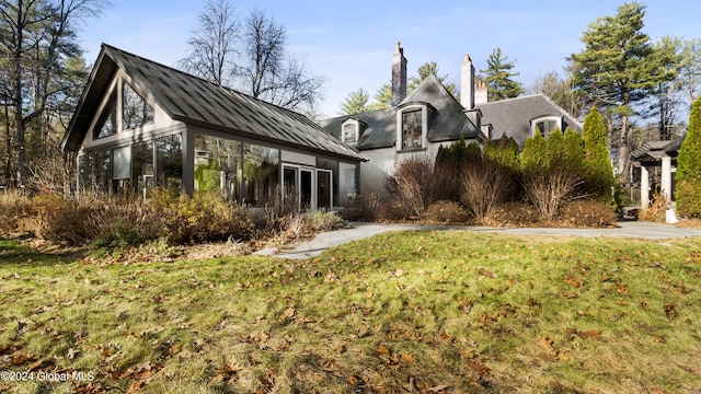 view of side of home featuring a lawn