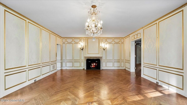 unfurnished living room with a notable chandelier and parquet flooring