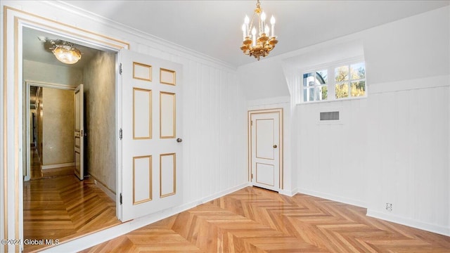 corridor with wooden walls, light parquet floors, a chandelier, and ornamental molding