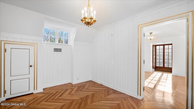 interior space featuring parquet floors, a chandelier, and plenty of natural light