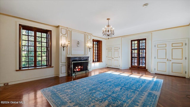 living room featuring dark parquet floors, ornamental molding, french doors, and a premium fireplace