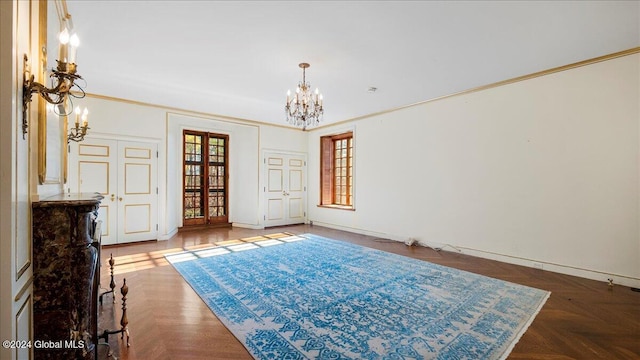 spare room with crown molding, dark parquet floors, and a chandelier