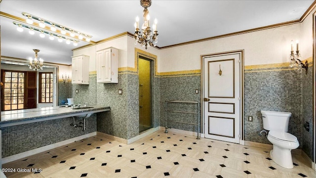 bathroom with sink, ornamental molding, a chandelier, and toilet