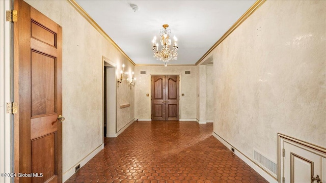 corridor with crown molding and a notable chandelier