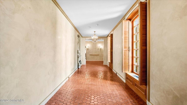 corridor with a chandelier and ornamental molding