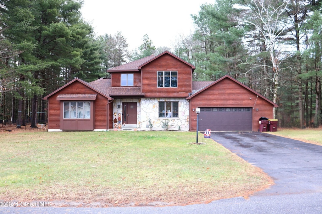 view of front of home featuring a garage and a front yard