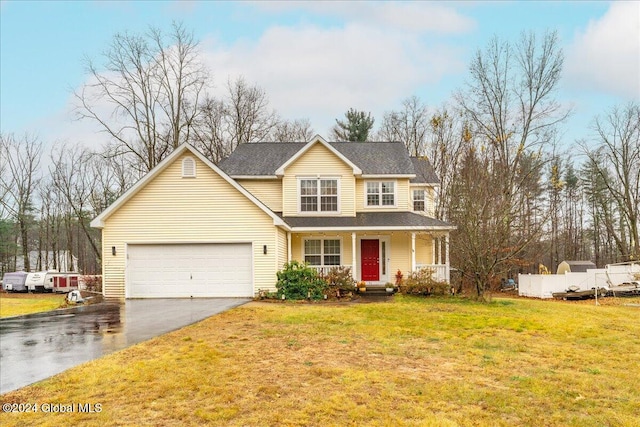 view of front of home featuring a front lawn, a porch, and a garage