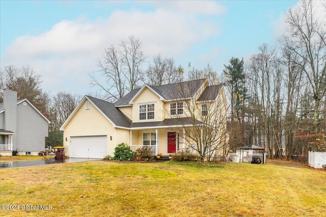 view of front of property featuring a porch, a garage, and a front yard