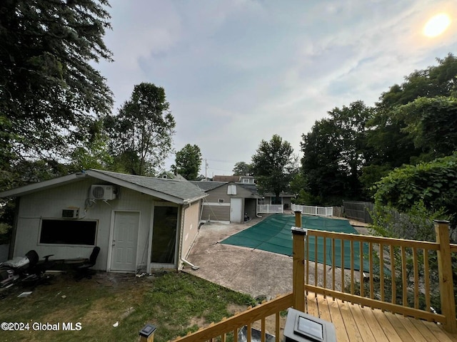 view of swimming pool with a wall mounted air conditioner, a patio, and a wooden deck