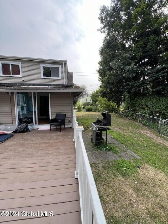 wooden terrace with a yard