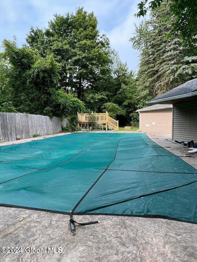 view of swimming pool featuring a deck