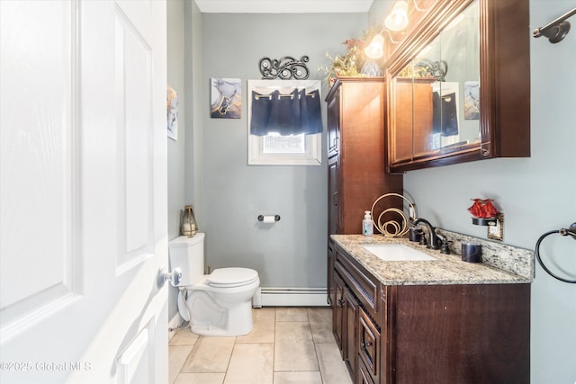 bathroom with vanity, a baseboard heating unit, tile patterned floors, and toilet