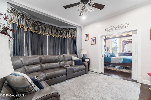 living room with ornamental molding, dark hardwood / wood-style floors, and ceiling fan