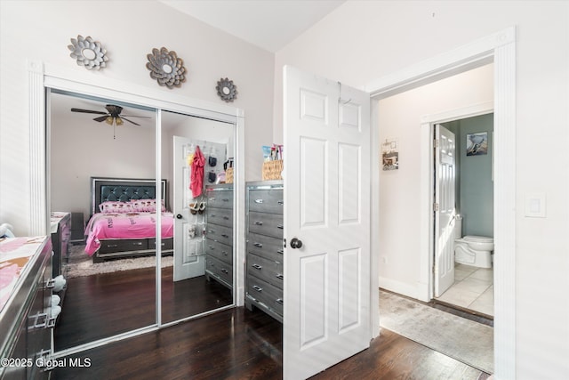 bedroom featuring wood-type flooring, a closet, and ensuite bathroom