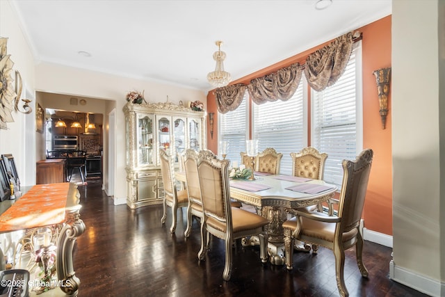 dining room with ornamental molding and dark hardwood / wood-style floors