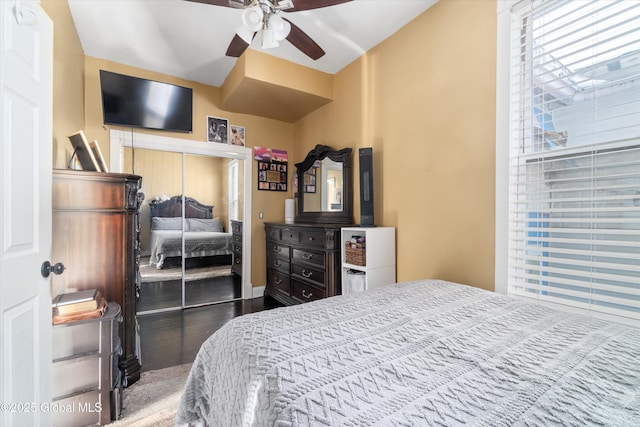 bedroom featuring multiple windows, a closet, and ceiling fan