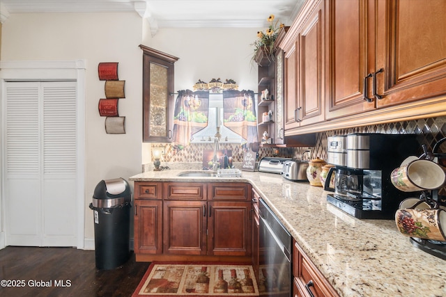 kitchen with light stone counters, sink, crown molding, and stainless steel dishwasher