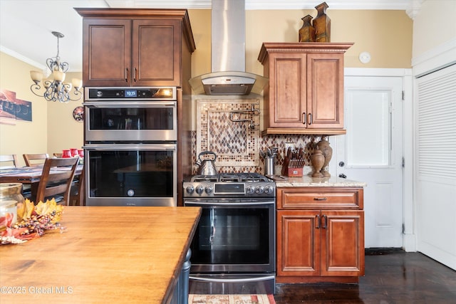 kitchen with wooden counters, appliances with stainless steel finishes, tasteful backsplash, extractor fan, and ornamental molding