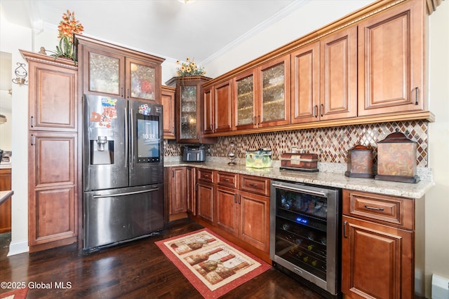 kitchen featuring wine cooler, light stone counters, crown molding, stainless steel fridge, and decorative backsplash