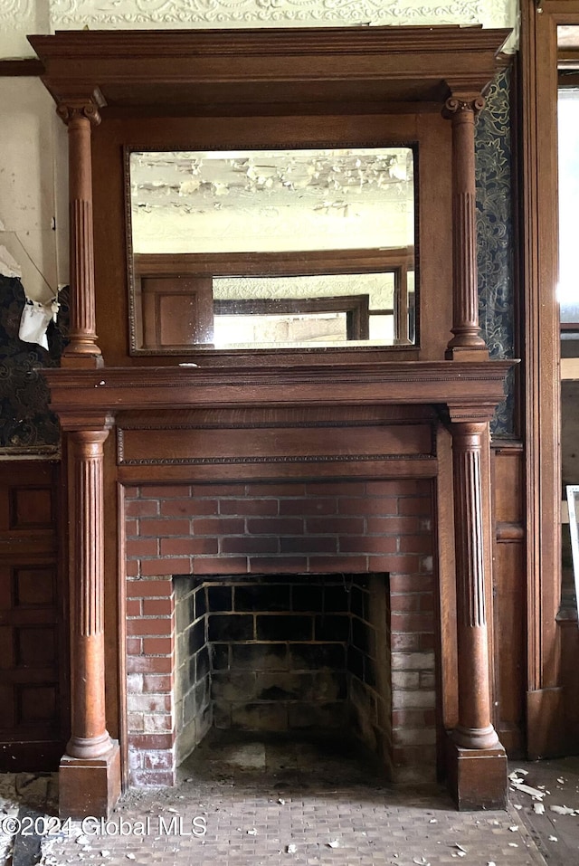 interior details with a brick fireplace