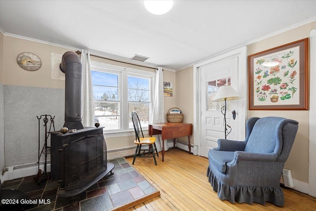 office space with crown molding, a baseboard radiator, wood-type flooring, and a wood stove