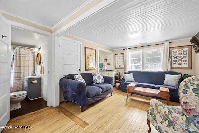 living room with hardwood / wood-style flooring and ornamental molding