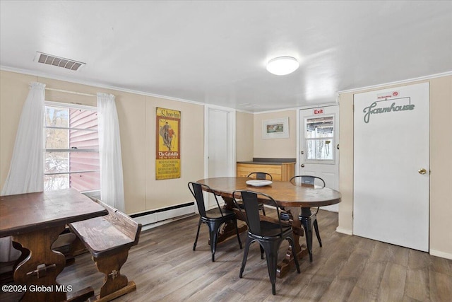 dining room with a baseboard radiator and hardwood / wood-style floors