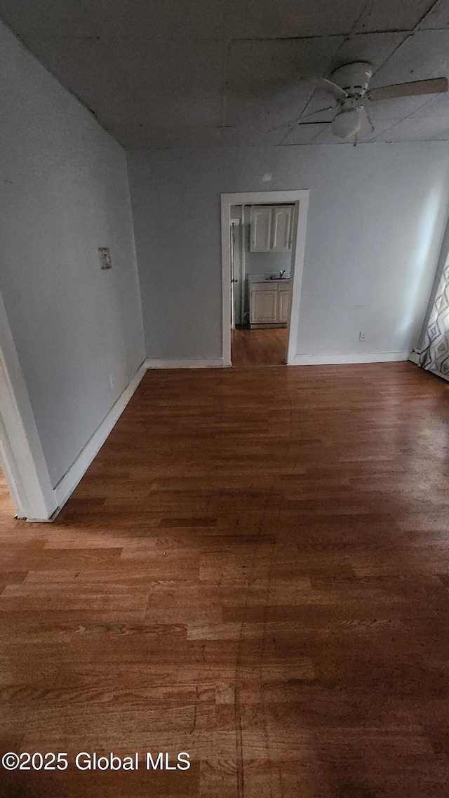 spare room with ceiling fan and wood-type flooring