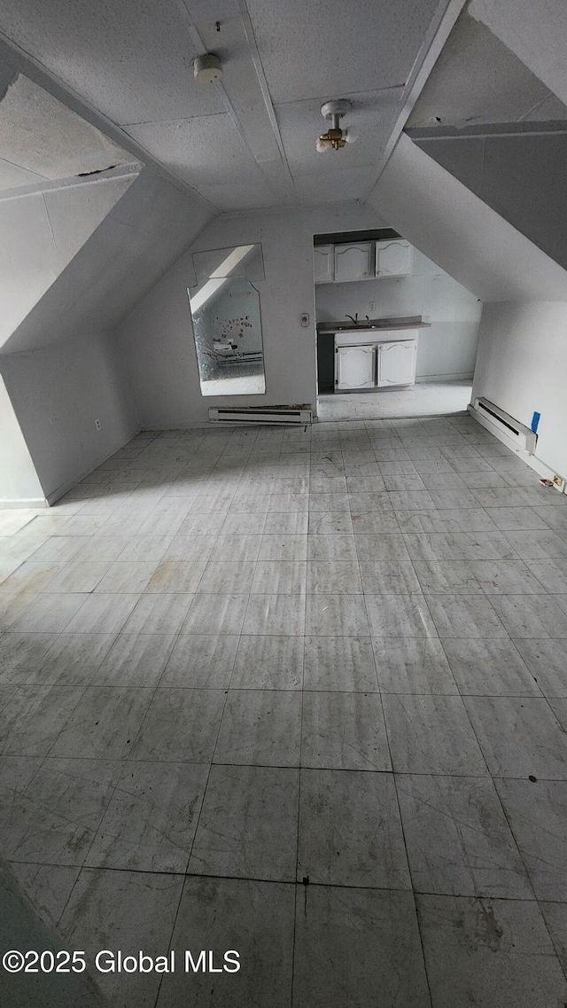 bonus room featuring a textured ceiling and vaulted ceiling