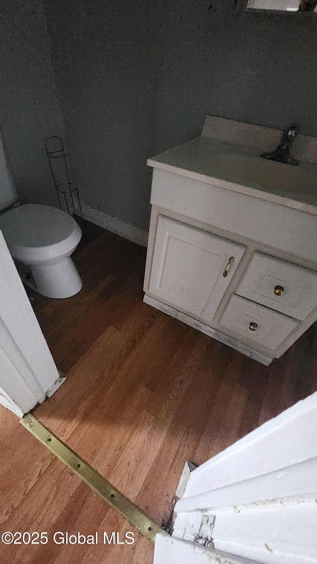 bathroom featuring hardwood / wood-style floors, vanity, and toilet