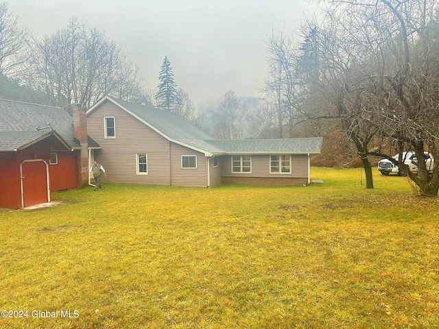 back of house with a lawn