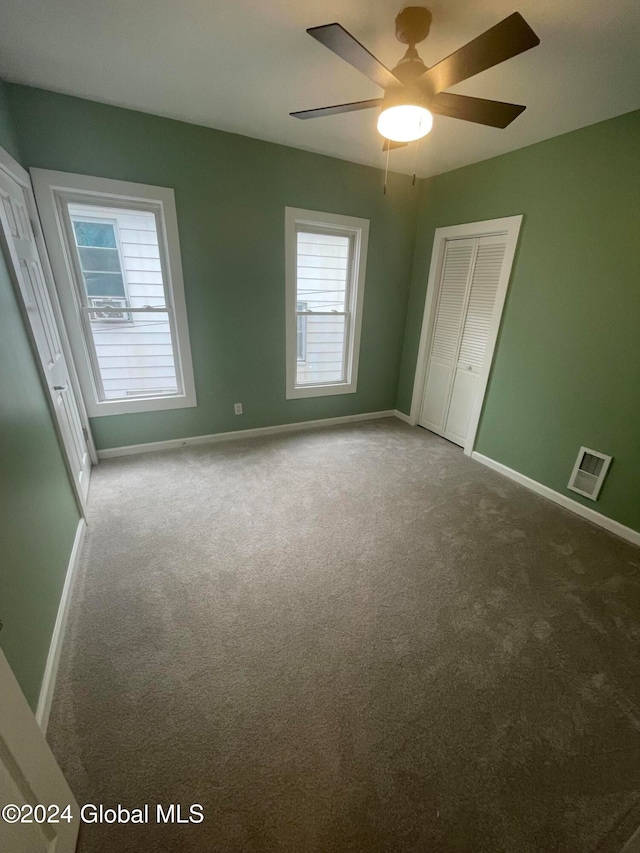 spare room with carpet flooring, plenty of natural light, and ceiling fan