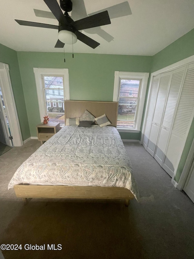 bedroom featuring multiple windows, carpet floors, and ceiling fan