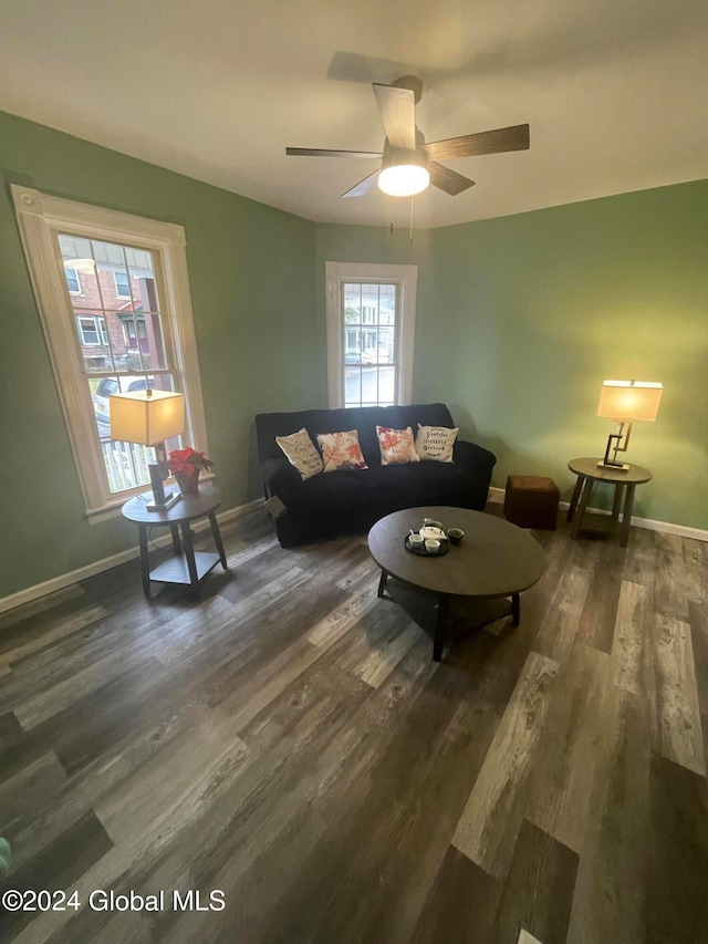 living room with dark hardwood / wood-style floors and ceiling fan