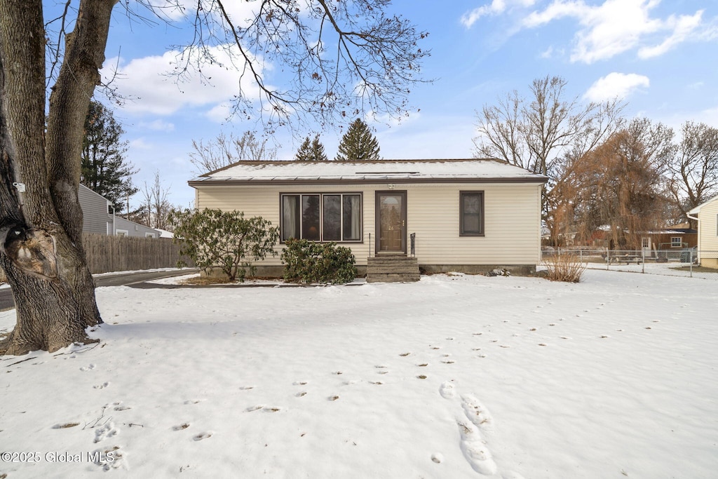 view of snow covered rear of property