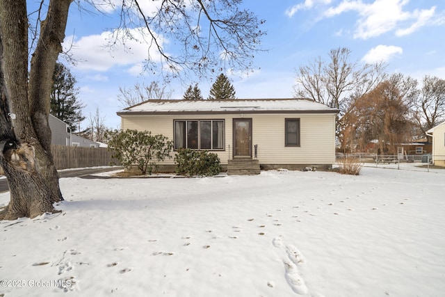 view of snow covered rear of property