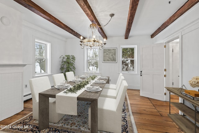 dining space with hardwood / wood-style floors, a baseboard heating unit, a wealth of natural light, and beam ceiling