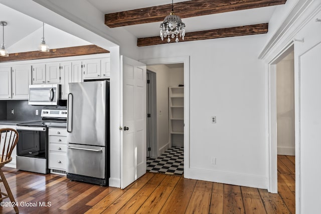 kitchen with stainless steel appliances, white cabinetry, dark wood-type flooring, and decorative light fixtures