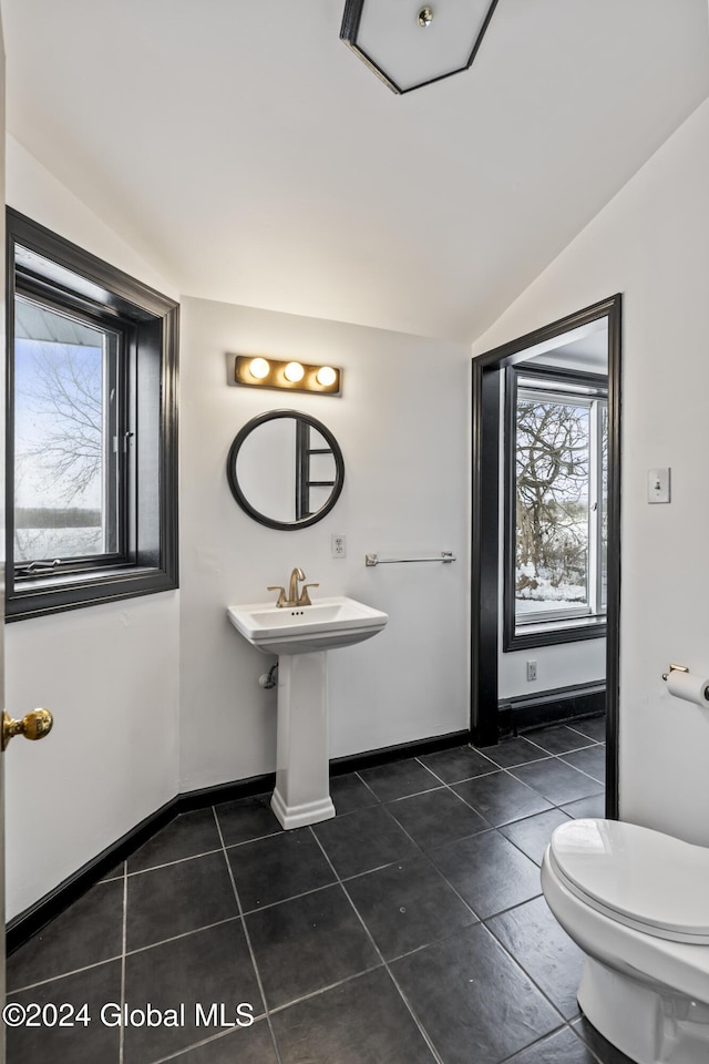 bathroom featuring tile patterned flooring, vaulted ceiling, plenty of natural light, and toilet