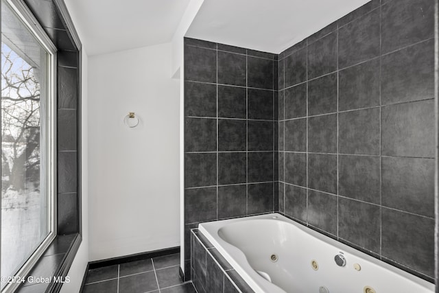 bathroom featuring tile patterned flooring and tiled tub