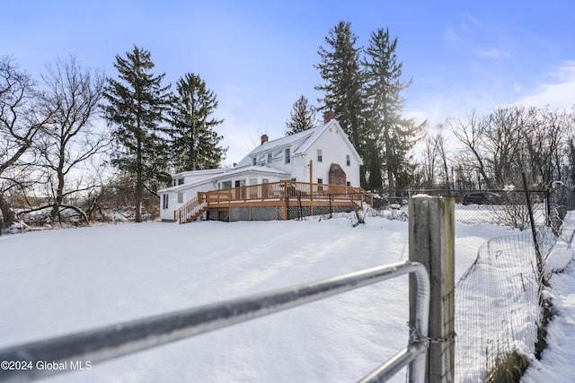 view of snowy exterior with a deck