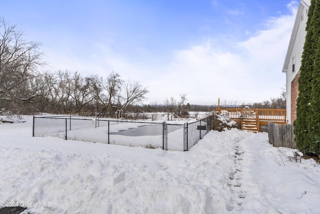 snowy yard featuring a deck