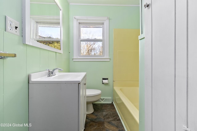 bathroom featuring a bathtub, toilet, and vanity