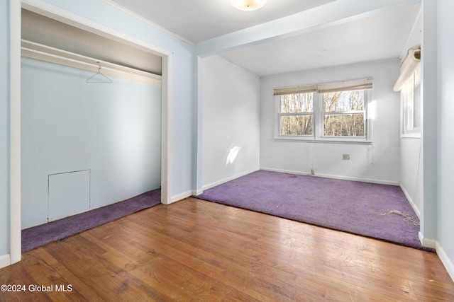 unfurnished bedroom featuring hardwood / wood-style flooring and a closet