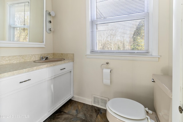 bathroom featuring vanity and toilet