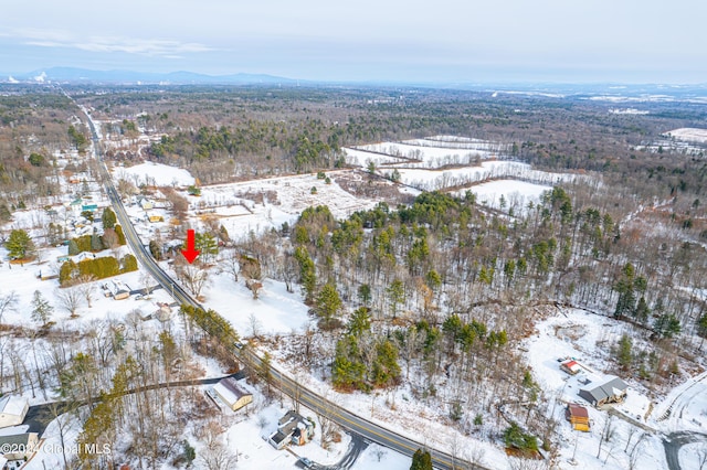 snowy aerial view featuring a mountain view