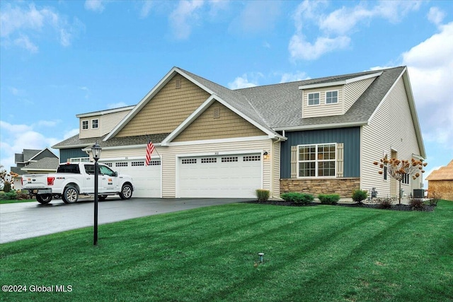 craftsman-style home with central AC unit, a garage, and a front lawn