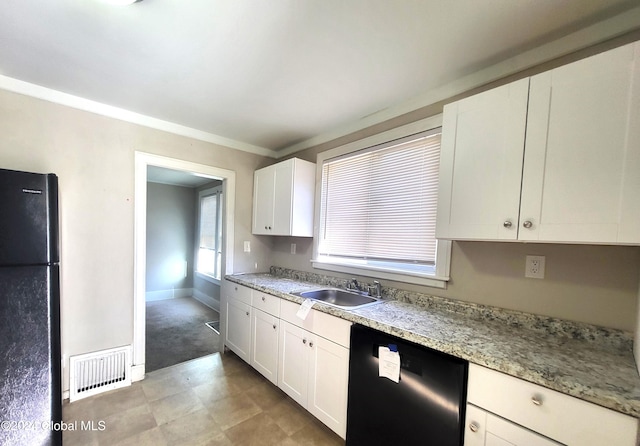 kitchen with light stone countertops, sink, crown molding, white cabinets, and black appliances